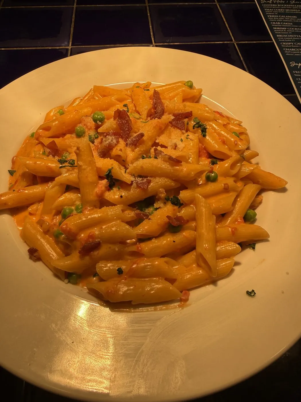 Penne alla vodka with prosciutto and spring peas